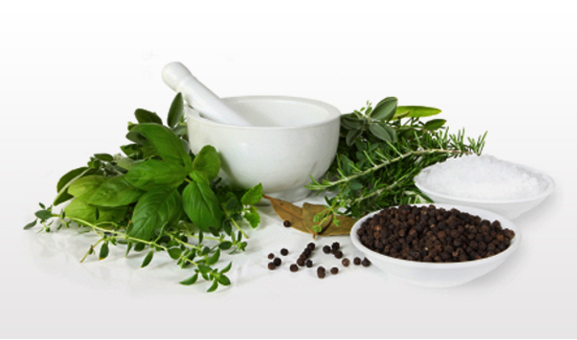 Fresh herbs beside a white mortar and pestle, with peppercorns and salt